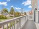 A charming balcony overlooking a well-manicured lawn and tree-lined street at 317 Alden Way, Carmel, IN 46032
