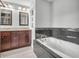 This bathroom offers a double vanity and a large bathtub with tiled surround at 317 Alden Way, Carmel, IN 46032