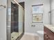 This bathroom has a tiled shower with glass doors, a sink, and a window at 317 Alden Way, Carmel, IN 46032