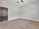 Minimalist bedroom with laminate flooring, neutral walls, and modern ceiling fan at 317 Alden Way, Carmel, IN 46032