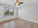 This bedroom has hardwood floors, a ceiling fan, and a window with a view at 317 Alden Way, Carmel, IN 46032