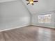 The primary bedroom boasts vaulted ceilings and hardwood floors with a large window at 317 Alden Way, Carmel, IN 46032
