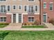 Townhome exterior with brick facade, concrete steps, and manicured lawn at 317 Alden Way, Carmel, IN 46032