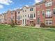 Well-maintained townhome complex with brick and beige siding and green lawns at 317 Alden Way, Carmel, IN 46032