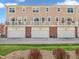 Townhome exterior with garages, balconies, and manicured landscaping at 317 Alden Way, Carmel, IN 46032