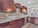 Close up of the kitchen with stainless steel appliances, granite countertops, and wooden cabinetry at 317 Alden Way, Carmel, IN 46032
