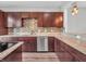Stylish kitchen features granite countertops, stainless steel appliances, and wooden cabinetry at 317 Alden Way, Carmel, IN 46032