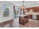 Bright kitchen with stainless appliances, granite countertops, and an island is adjacent to dining area at 317 Alden Way, Carmel, IN 46032