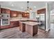 Kitchen with stainless appliances, stone backsplash, island, and pendant lighting provides ample space at 317 Alden Way, Carmel, IN 46032