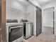 Bright laundry room with modern appliances and a convenient wire shelf for optimal storage solutions at 317 Alden Way, Carmel, IN 46032