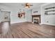 Open living room boasts a fireplace, ceiling fan, and an archway to a bright front entryway at 317 Alden Way, Carmel, IN 46032