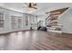 Spacious living room with laminate floors, natural light, and modern staircase at 317 Alden Way, Carmel, IN 46032