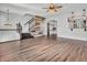 Open-concept living area with laminate floors, staircase, and stylish decor at 317 Alden Way, Carmel, IN 46032