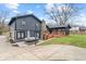 Backyard with a wooden deck, stone chimney, hot tub, grey siding, and green grass at 3244 Devereaux Dr, Indianapolis, IN 46228