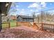 Backyard deck with wooden railings offering serene views of a detached garage at 3244 Devereaux Dr, Indianapolis, IN 46228