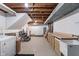 Unfinished basement with laundry, storage, and utility sink space at 3244 Devereaux Dr, Indianapolis, IN 46228