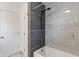 Bathroom featuring tiled bathtub with black shower fixtures and neutral gray accent at 3244 Devereaux Dr, Indianapolis, IN 46228