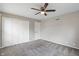 Neutral bedroom with plush carpet, ceiling fan, a closet, and white door at 3244 Devereaux Dr, Indianapolis, IN 46228