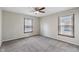 Comfortable bedroom with neutral tones, ceiling fan, plush carpeting, and two windows that offer great natural light at 3244 Devereaux Dr, Indianapolis, IN 46228