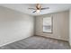 Neutral bedroom with plush carpet, ceiling fan, and a window with natural light at 3244 Devereaux Dr, Indianapolis, IN 46228