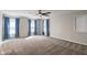 Large bedroom with cozy carpeting and blue curtains that let in sunlight at 3244 Devereaux Dr, Indianapolis, IN 46228