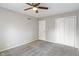 Neutral bedroom with plush carpet, ceiling fan, a closet, and white door at 3244 Devereaux Dr, Indianapolis, IN 46228