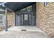 Close-up of the front entrance of a home featuring a decorated glass door, stone facade and modern lighting at 3244 Devereaux Dr, Indianapolis, IN 46228