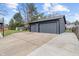 Exterior shot of detached two-car garage with asphalt driveway and gray siding at 3244 Devereaux Dr, Indianapolis, IN 46228