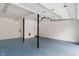 Spacious two car garage featuring a neutral paint scheme and modern lighting at 3244 Devereaux Dr, Indianapolis, IN 46228