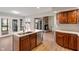 Charming kitchen with stainless steel appliances, an island, and stone fireplace nearby at 3244 Devereaux Dr, Indianapolis, IN 46228