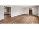 Open-concept living room with hardwood floors and access to the staircase at 3244 Devereaux Dr, Indianapolis, IN 46228
