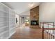 Bright living room showcasing a stone fireplace, wood floors, white shelving, and sliding glass doors to the exterior at 3244 Devereaux Dr, Indianapolis, IN 46228