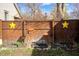 Fenced backyard with decorative stars, and small decorative fountain at 331 W State St, Pendleton, IN 46064