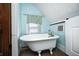 Bathroom has a vintage claw foot tub and blue walls at 331 W State St, Pendleton, IN 46064