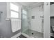 Modern bathroom boasts a glass shower with white subway tile and gray mosaic tile flooring at 331 W State St, Pendleton, IN 46064