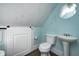 Small bathroom has a pedestal sink, toilet and barn door access at 331 W State St, Pendleton, IN 46064