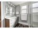 Modern bathroom with a vanity, decorative mirror, and a tiled glass shower at 331 W State St, Pendleton, IN 46064