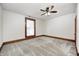 Bedroom features neutral carpet, white walls with wood trim, and a ceiling fan with light at 331 W State St, Pendleton, IN 46064