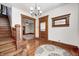 Elegant foyer showcasing hardwood floors, a staircase, and an ornate chandelier at 331 W State St, Pendleton, IN 46064
