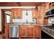 Traditional kitchen offers wood cabinetry, granite countertops, and modern stainless appliances at 331 W State St, Pendleton, IN 46064