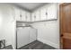 Bright laundry room features a washer and dryer and built-in cabinets at 331 W State St, Pendleton, IN 46064