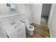 The bathroom has a laminate floor, white vanity, and standard toilet at 3662 Lombardy Pl, Indianapolis, IN 46226