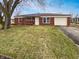 Charming one-story brick home featuring an attached garage and well-maintained front lawn at 3662 Lombardy Pl, Indianapolis, IN 46226