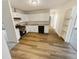 Well-lit kitchen with white cabinets, modern appliances, and durable wood flooring at 3662 Lombardy Pl, Indianapolis, IN 46226