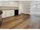 Galley kitchen featuring wood floors, white cabinets, and stainless appliances at 3662 Lombardy Pl, Indianapolis, IN 46226