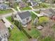 An aerial view showcases the home's backyard, mature trees, and neighborhood at 3892 Pelham Rd, Carmel, IN 46074