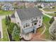 An aerial view of the house shows the deck, stone patio, landscaped yard, and neighborhood at 3892 Pelham Rd, Carmel, IN 46074
