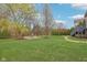 Spacious backyard with manicured lawn, garden landscaping and a stone patio area with fountain at 3892 Pelham Rd, Carmel, IN 46074