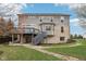 The home's back exterior shows a brick and vinyl facade, deck, and sprawling lawn at 3892 Pelham Rd, Carmel, IN 46074