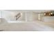 Finished basement with neutral carpet, staircase, and wet bar area featuring light wood cabinets and granite countertops at 3892 Pelham Rd, Carmel, IN 46074